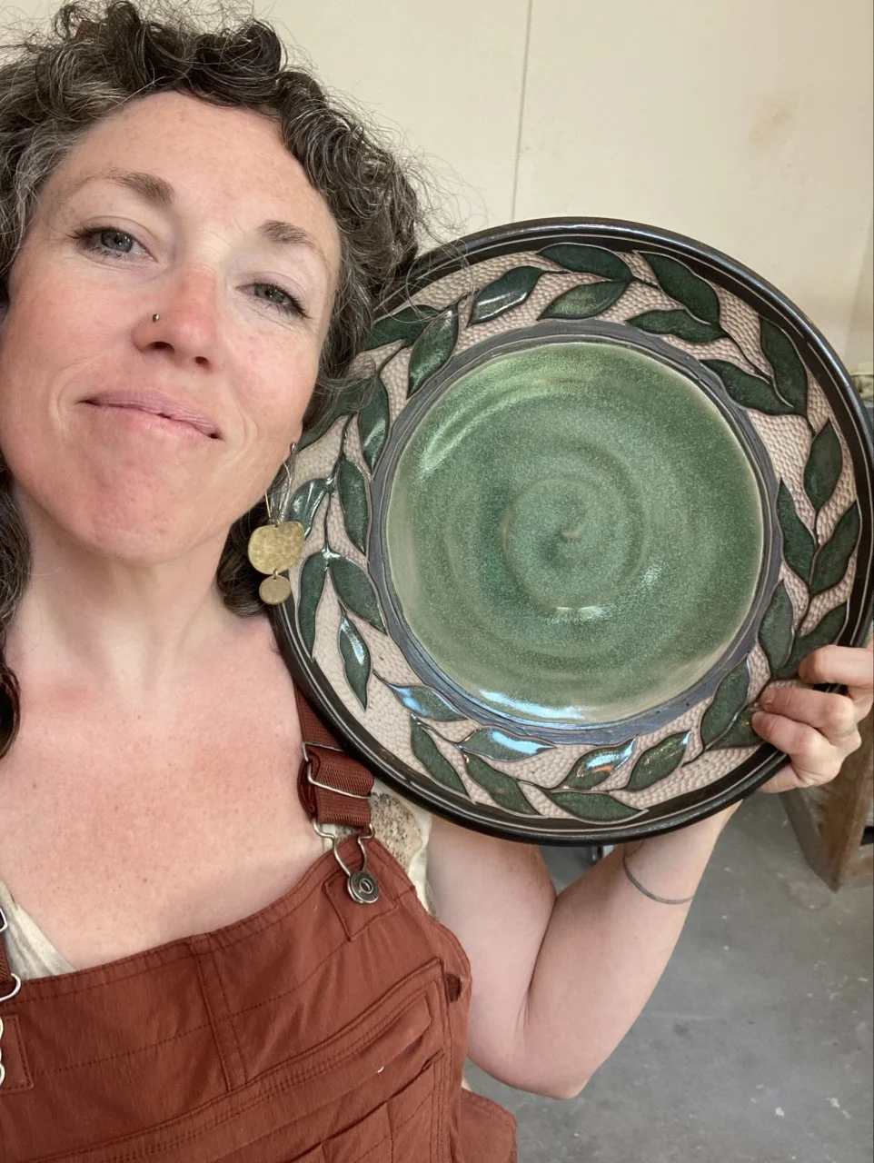 Painted and carved bowl with leaves around the edge