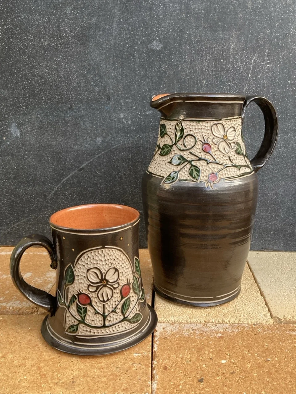 Mug and pitcher with floral decorations