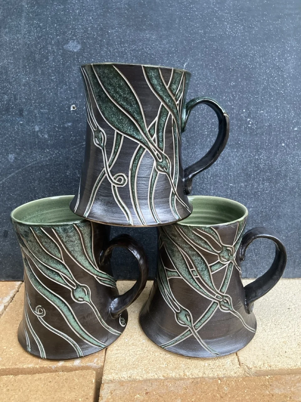 Three mugs with seaweed decoration
